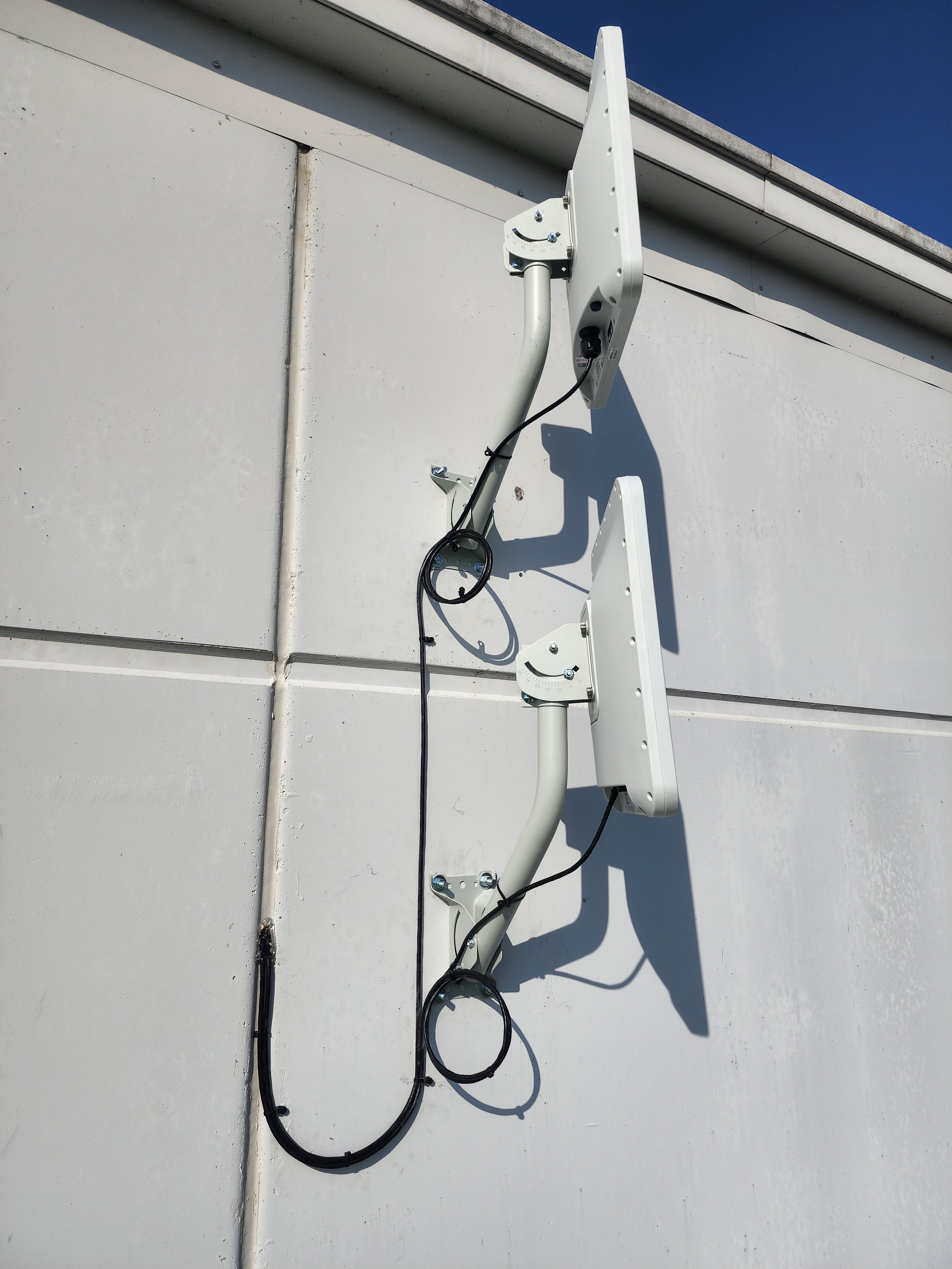 Three outdoor wireless radios installed on a building by NextGen Solutions